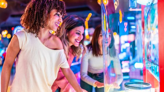 Classic arcade cabinets glowing in a dark room